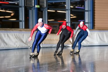Three speed skaters clipart