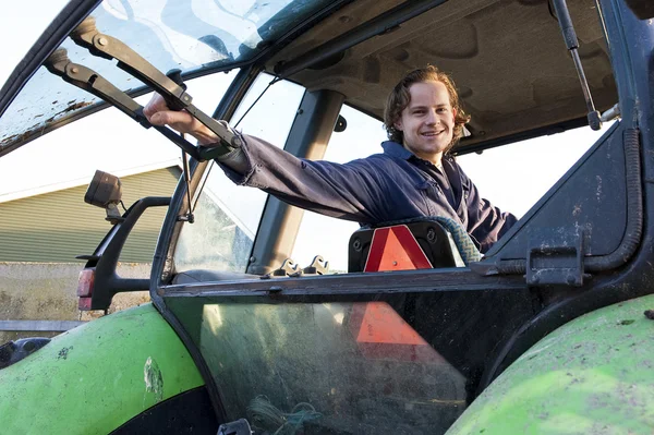 Farm hand in a tractor — Stock Photo, Image