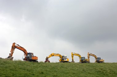 Four diggers on a dyke clipart