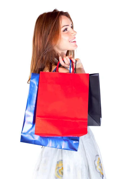 Vonzó fiatal gyönyörű nő, bevásárló táskák, mint fehér háttér. — Stock Fotó