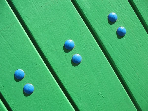 A fragment of a wooden door with bolts — Stock Photo, Image