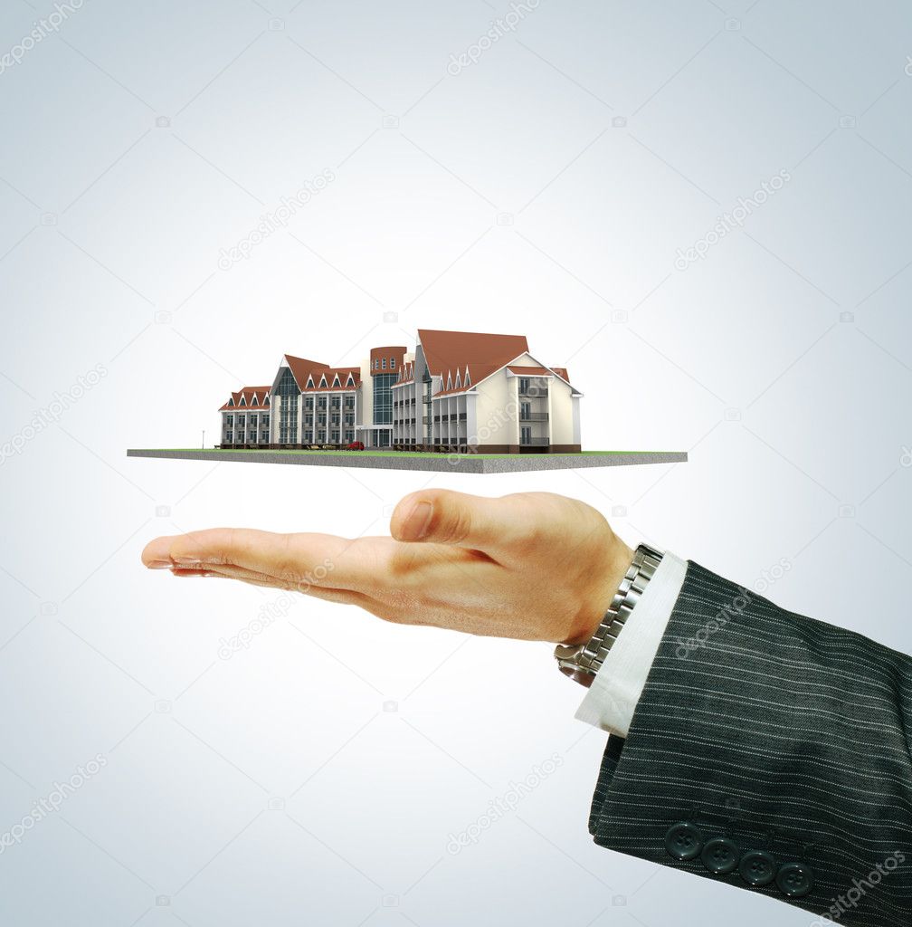 Hotel building in businessman's hand