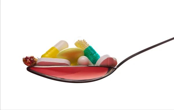 Spoon full of various pills — Stock Photo, Image