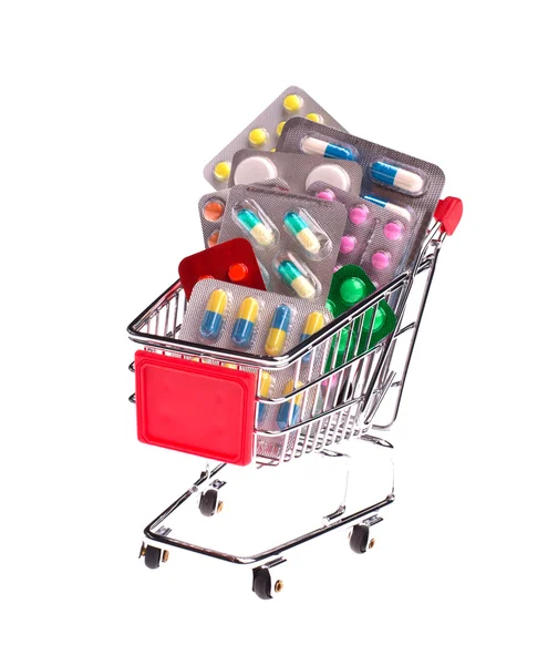 Pequeño carrito de compras lleno de pastillas — Foto de Stock