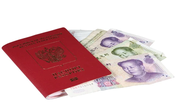 Stock image International passport and Chinese yuans