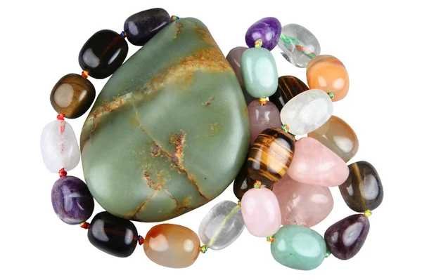 Nephrite and beads from semi-precious stones — Stock Photo, Image