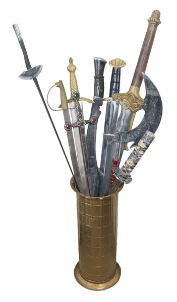 Espadas sortidas em um suporte de latão — Fotografia de Stock