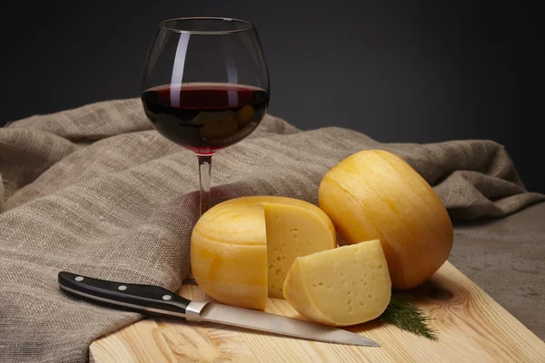 Cheese wheels with wine — Stock Photo, Image
