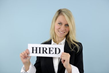 Young busineswoman holding hired sign clipart