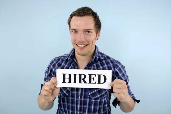 Young man holding hired sign — Stock Photo, Image