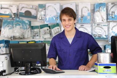 Portrait of a sales assistant behind the counter clipart