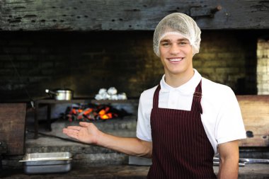 Man working at a restaurant showing wood-fired oven clipart