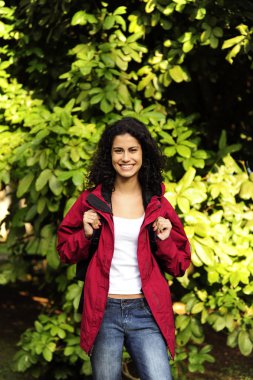 Ecotourism: woman hiking in the forest clipart