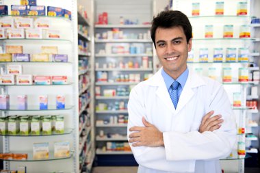 Portrait of a male pharmacist at pharmacy clipart