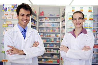 Portrait of pharmacists at pharmacy clipart