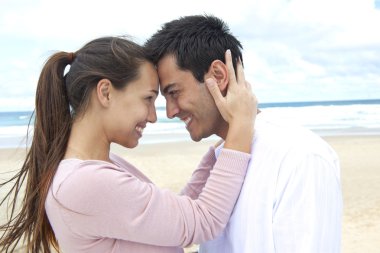 Couple in love on the beach flirting clipart