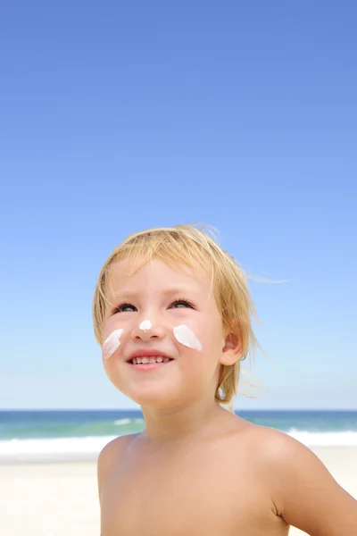 Słodkie dziecko z filtrem przeciwsłonecznym na plaży — Zdjęcie stockowe
