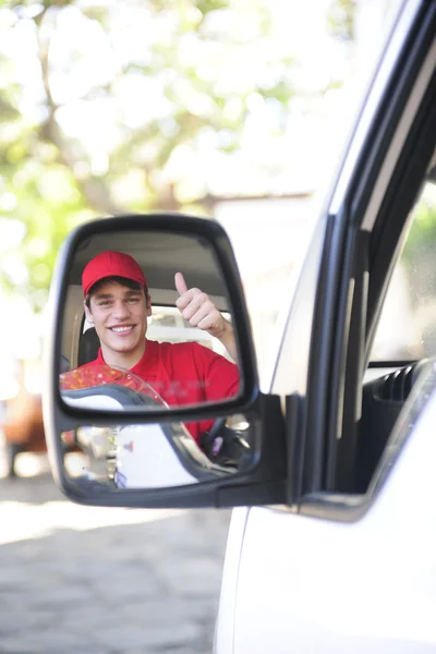 Delivery courier in van, rear view mirror — Stock Photo, Image