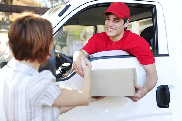 Delivery courier delivering package and handshake — Stock Photo, Image