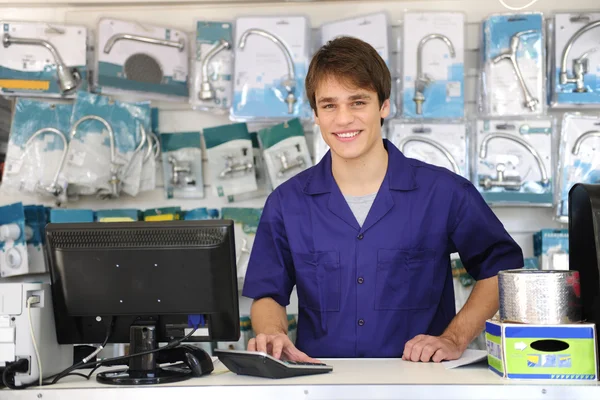Portrait of a sales assistant behind the counter — Stock Photo, Image