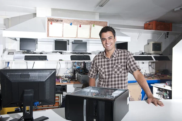 Happy owner of a computer repair store — Stock Photo, Image