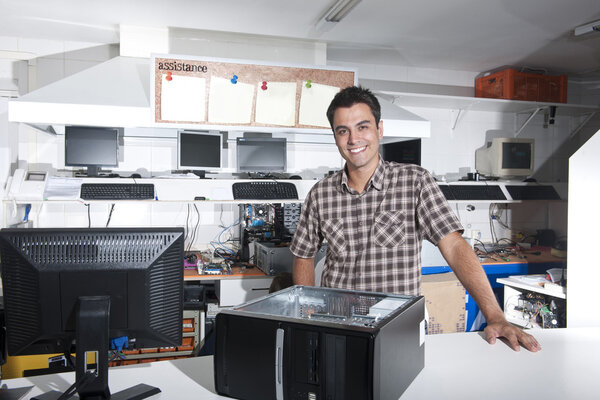 Happy owner of a computer repair store