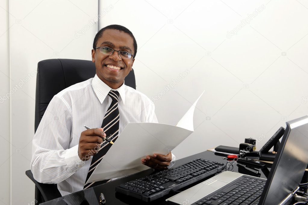 Happy bookkeeper reading documents at desk