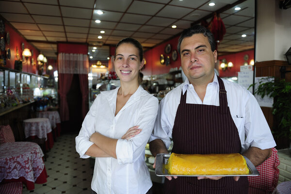 Small business: female owner of a cafe and waiter