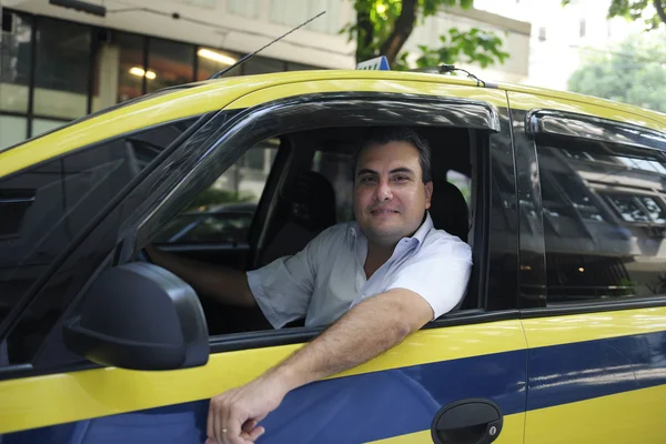 Portrait of a taxi driver with cab — Stock Photo, Image