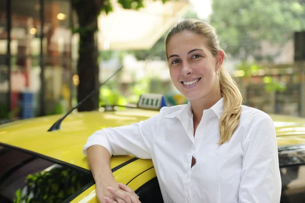 Portrait of a female taxi driver with her new cab — Stock Photo, Image
