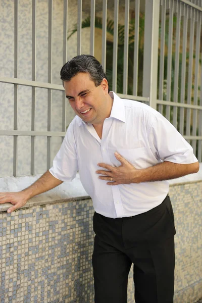 Muž s srdeční infarkt ohýbání — Stock fotografie