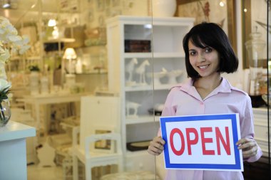 Small business owner: woman holding an open sign clipart