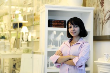 Small business owner: proud woman and her store clipart