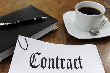 Contract and coffee on a desk clipart