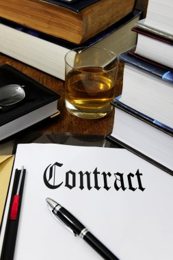 Contract and whiskey on a desk clipart