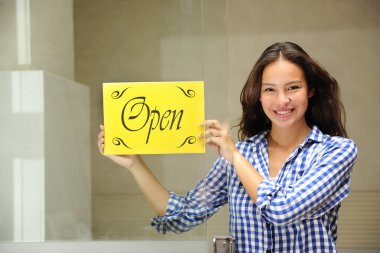 Happy owner of a cafe showing open sign clipart