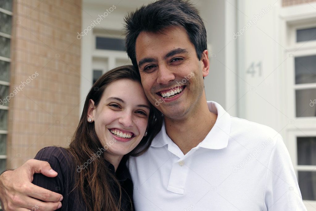 Couple standing outside new house