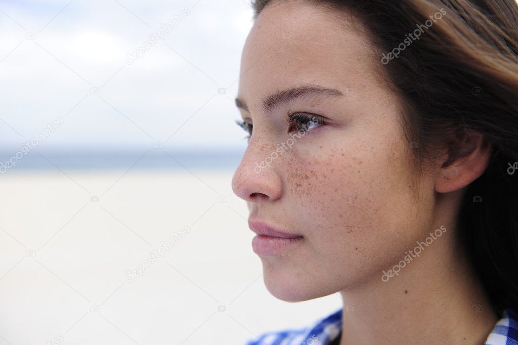 Beautiful woman by the beach with copy space