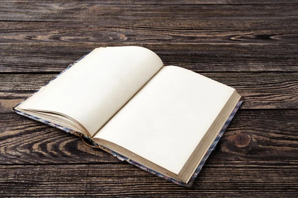 Aged blank book on wooden table — Stock Photo, Image