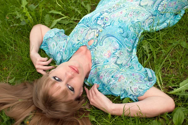 The girl on a grass in a turquoise dress — Stock Photo, Image