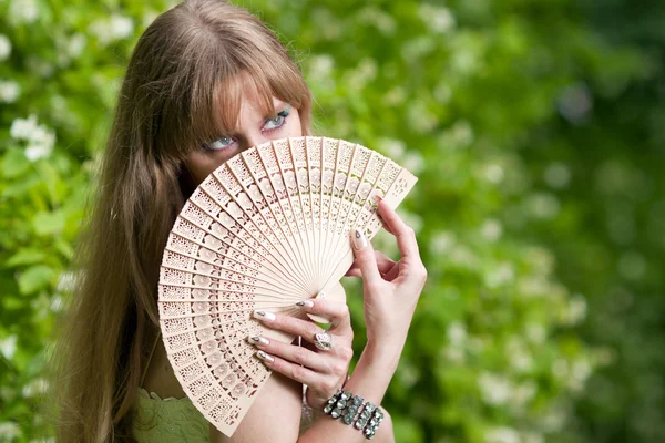 Woman's face and fan — Stock Photo, Image