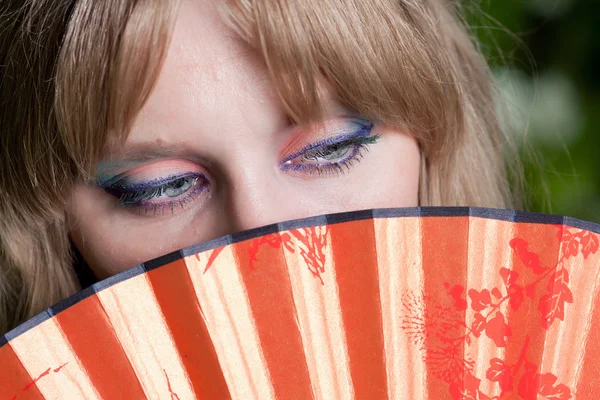 Eyes and a fan — Stock Photo, Image
