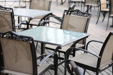 Empty tables in street cafe clipart