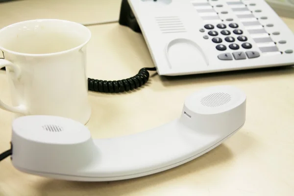 Cup and telephone — Stock Photo, Image