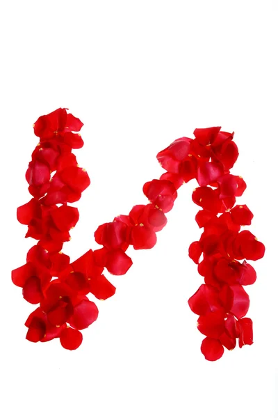 Płatki róż tworzące literę — Zdjęcie stockowe