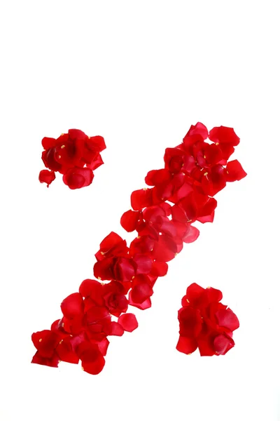 Pétalas vermelhas de rosa formando símbolos — Fotografia de Stock