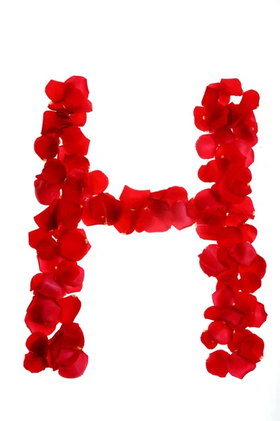 Pétales de rose formant lettre — Photo