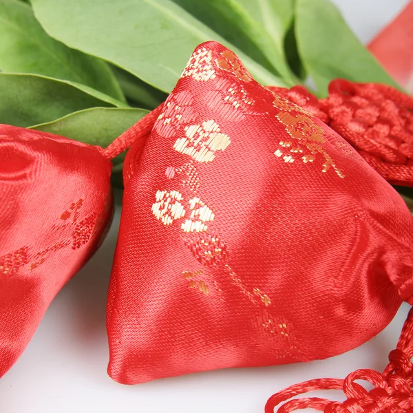 Red embroidery Sachet and plants — Stock Photo, Image