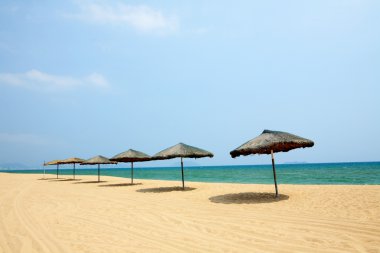 Sunshade and chairs on beach, Sanya, China clipart