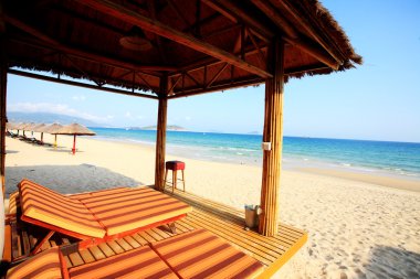 Sunshade and chairs on beach, Sanya, China clipart